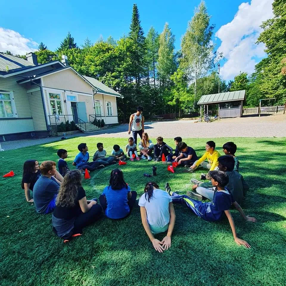 Norden International School building in Malmi, Helsinki, with students gathered outdoors